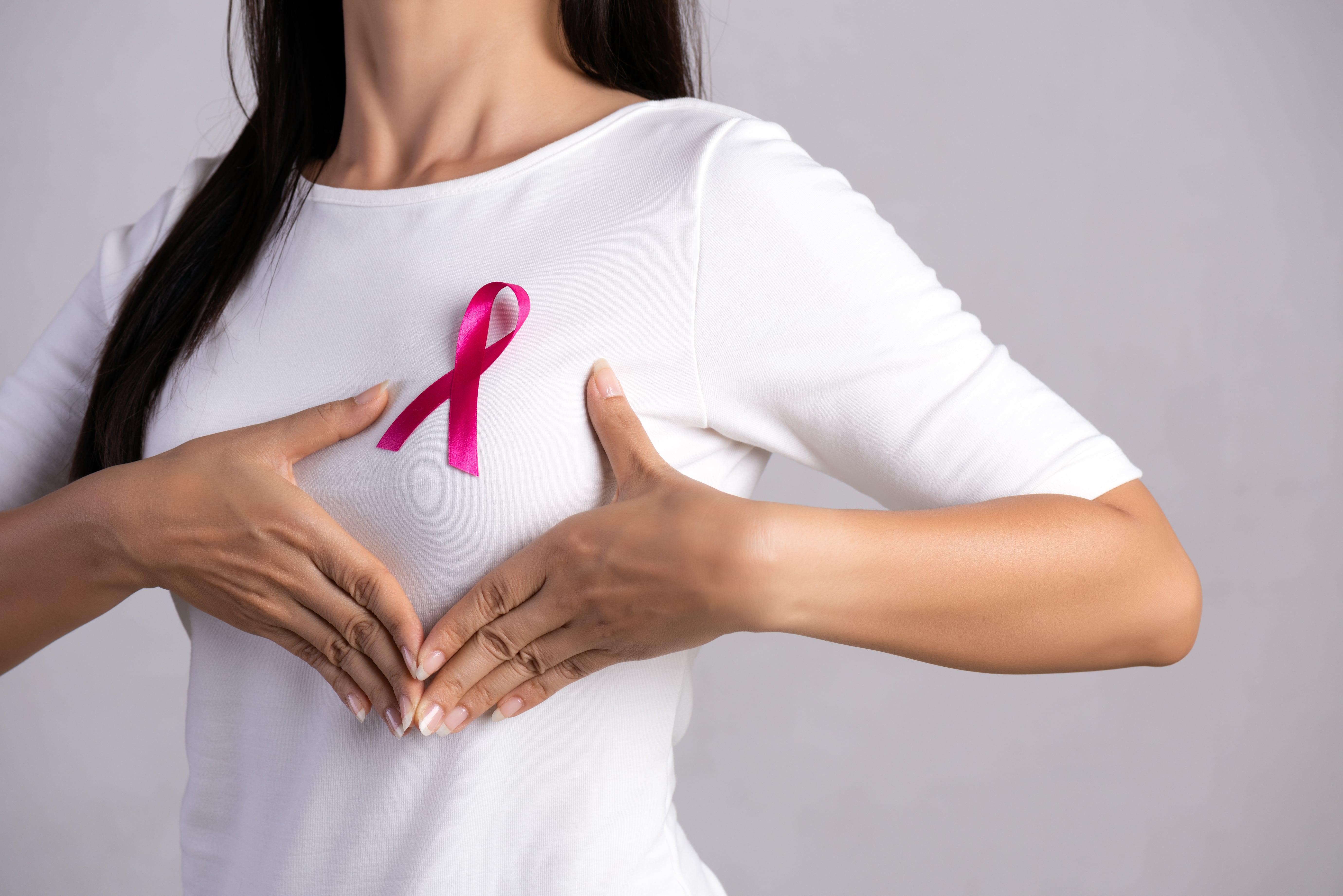 pink-badge-ribbon-woman-chest-support-breast-cancer-cause-healthcare-concept-min